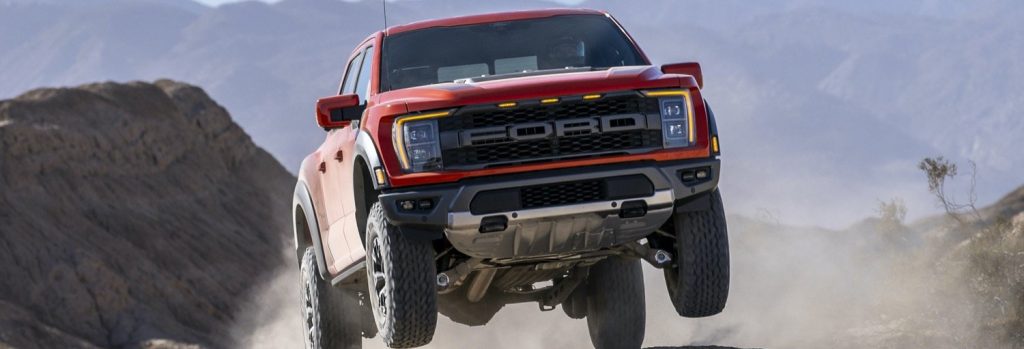 2021-Ford-F-150-Raptor-Exterior-085-Code-Orange-Raptor-37-performance-package-front-three-quarters-jumping
